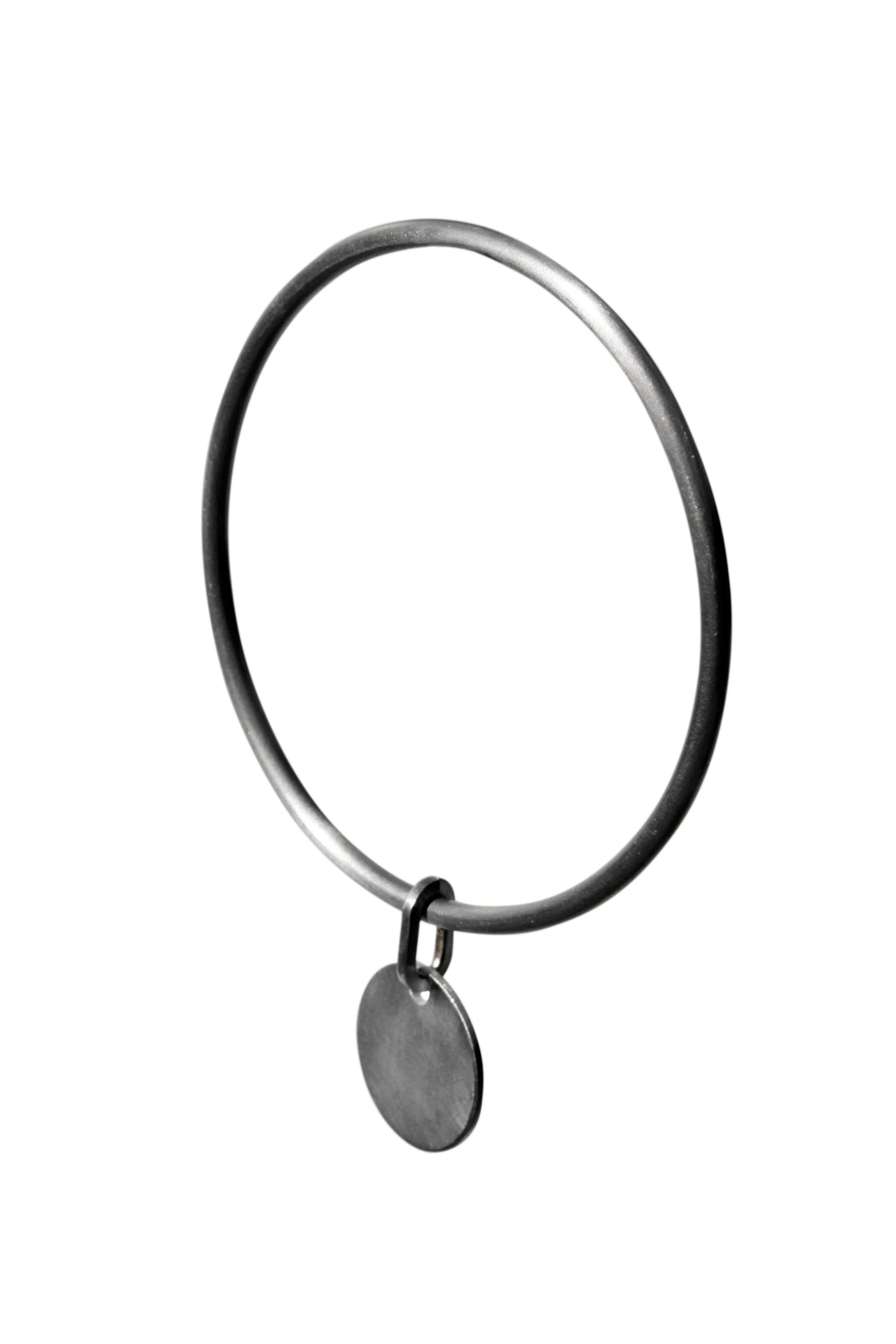 Silver bangle with disc charm